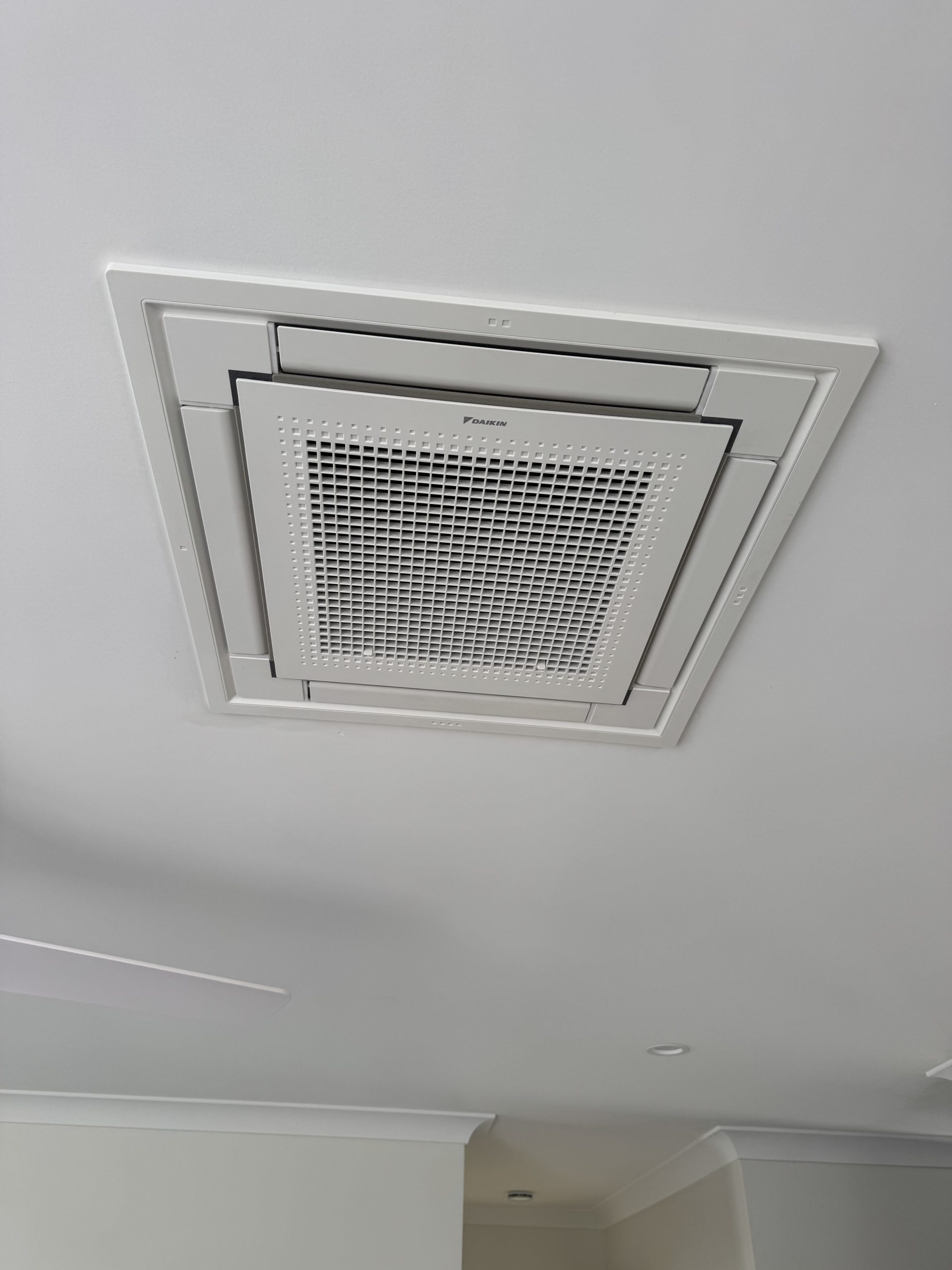 Ducted air conditioning ceiling diffuser and grille neatly finished in a Sunshine Coast home